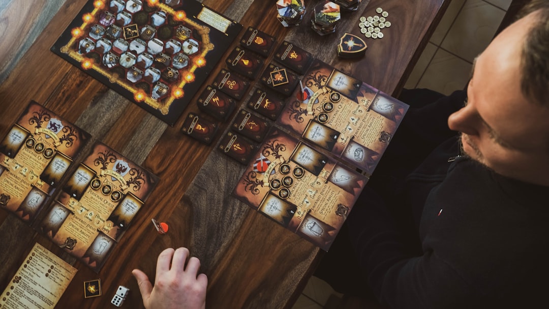 Top-down view of two friends playing a board game.
